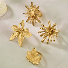 Wholesale Stainless Steel Jewelry Sun and Flower Rings Displayed on Textured Aesthetic Background