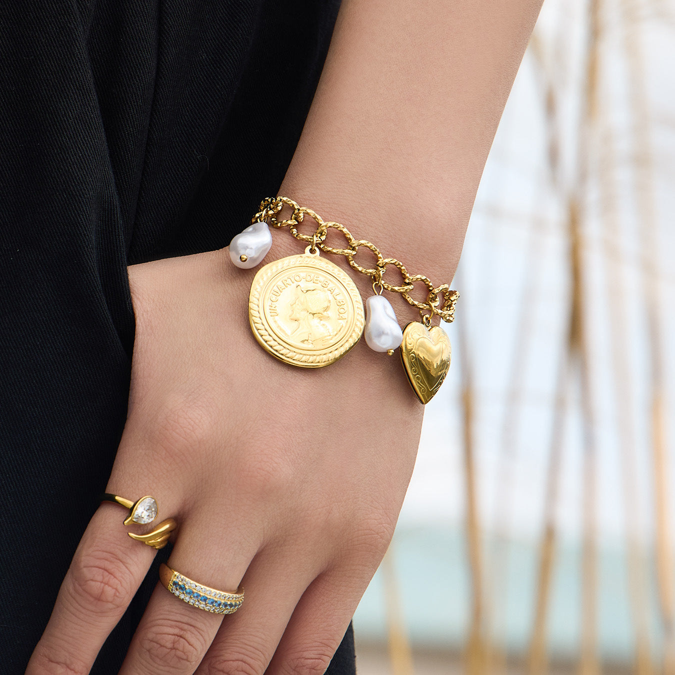gold heart charm bracelet with coin and pearl charms on stainless steel chain