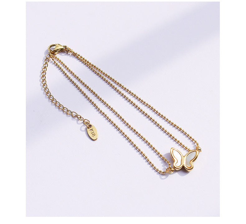 Butterfly charm detail on 316L stainless steel 18K PVD gold anklet with fine chain, hypoallergenic waterproof jewelry for sensitive skin