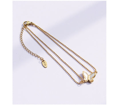 Butterfly charm detail on 316L stainless steel 18K PVD gold anklet with fine chain, hypoallergenic waterproof jewelry for sensitive skin