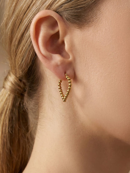Round Shape Twisted Hoop Earrings worn on ear, trendy stainless steel statement earrings