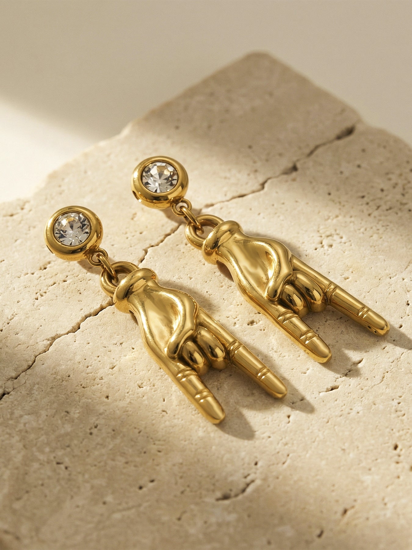 Hand Gesture Zircon Earrings on display, 316L stainless steel hypoallergenic jewelry