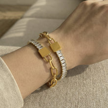 Model wearing 18K gold PVD 316L stainless steel 5A zircon lock link chain bracelet, waterproof stackable style