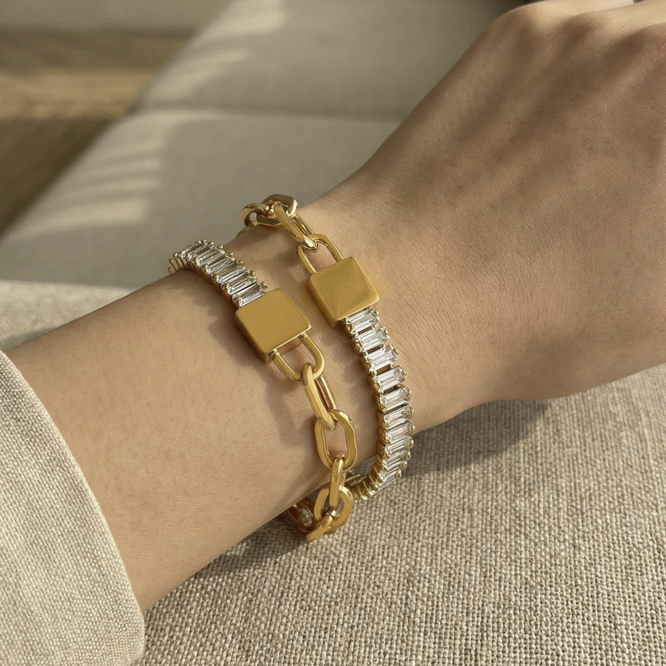 Model wearing 18K gold PVD 316L stainless steel 5A zircon lock link chain bracelet, waterproof stackable style