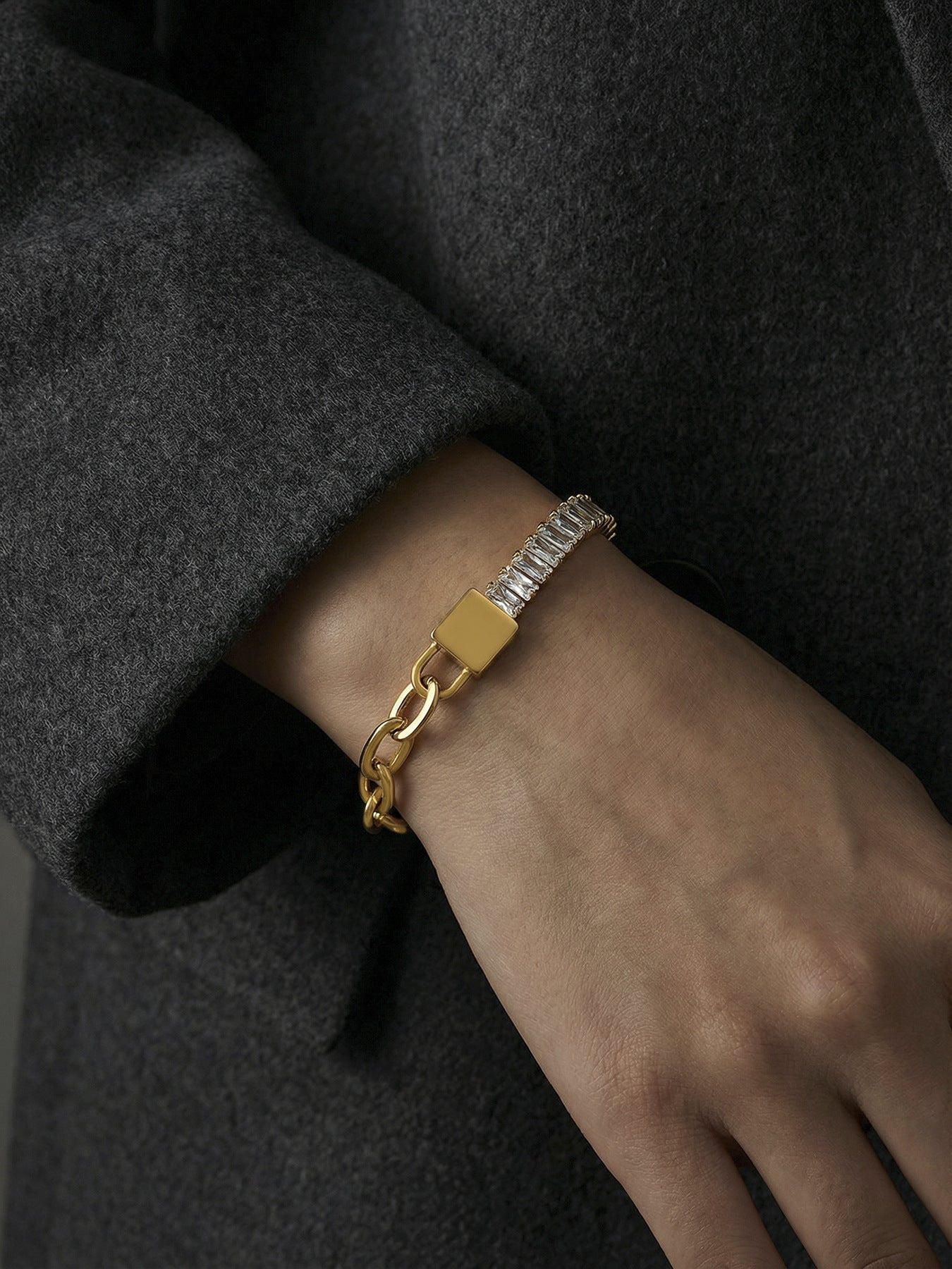 Hand wearing 316L stainless steel 5A zircon lock link bracelet, steel finish with PVD gold accents, hypoallergenic