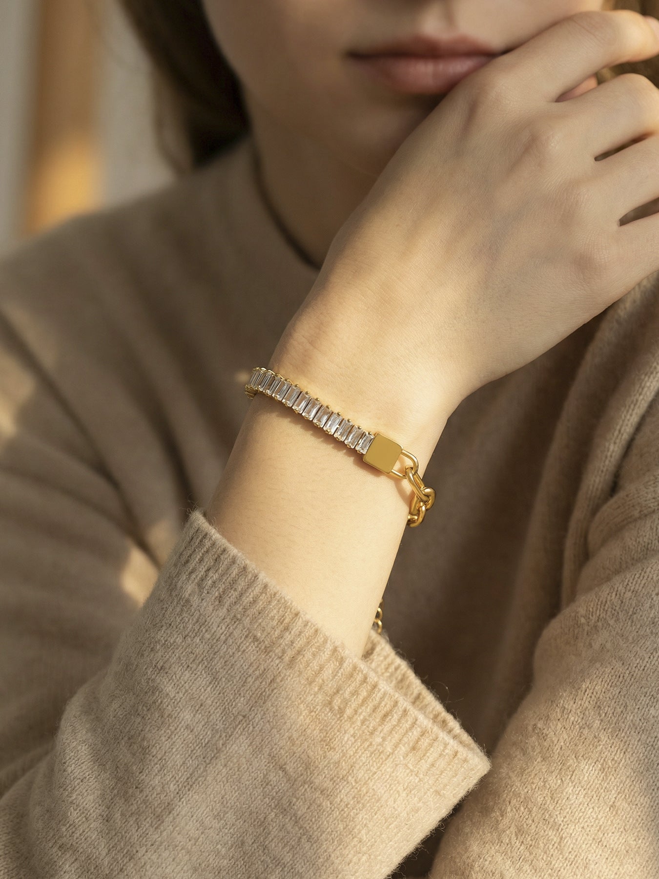 Side view of model wearing 316L stainless steel 18K gold PVD zircon lock link bracelet, layered waterproof jewelry