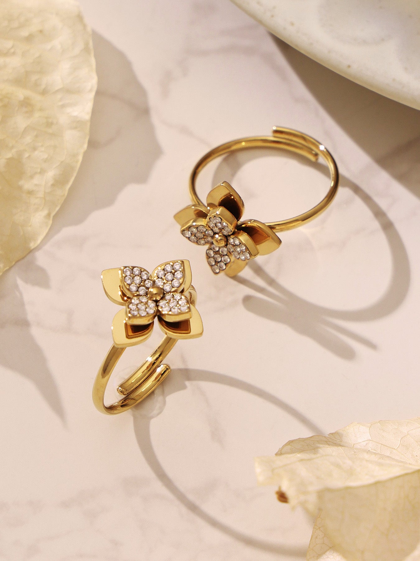 Close-up of a four-petal flower charm bracelet on a model’s wrist, demonstrating a stylish and tarnish-free jewelry choice.
