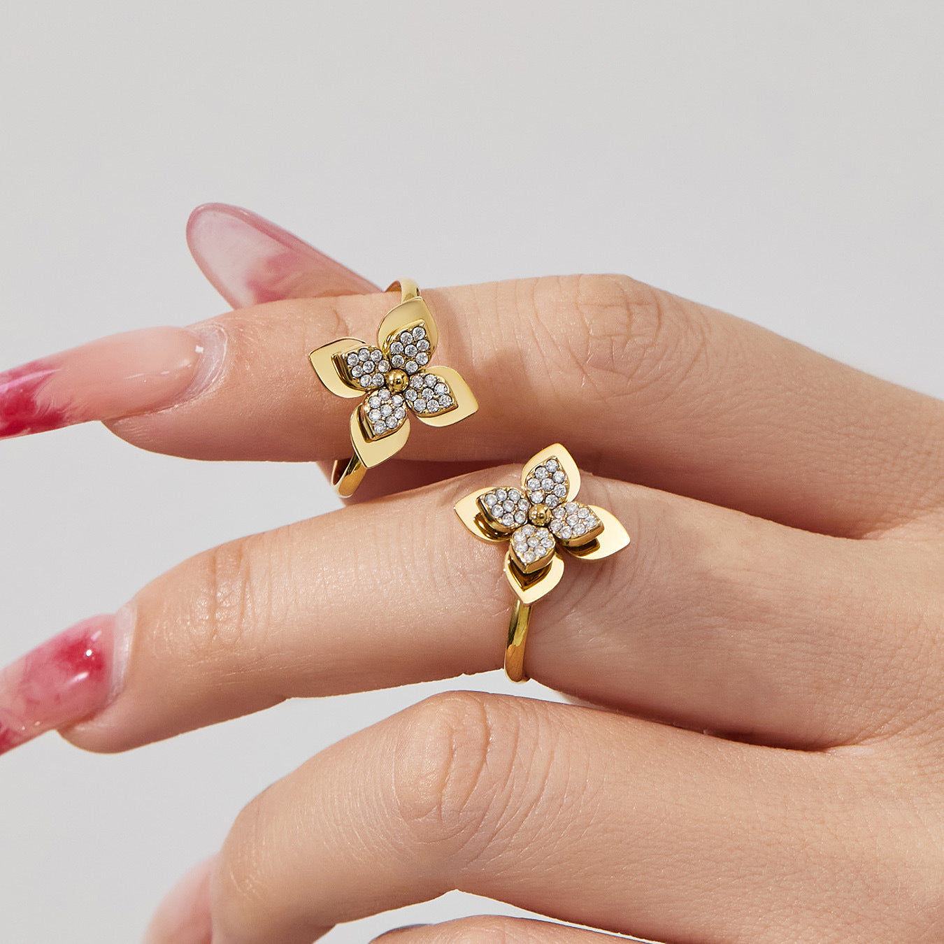 Sparkling zircon four-petal flower ring worn on a finger, part of our hypoallergenic jewelry for sensitive skin.