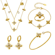 A complete 316L stainless steel four-petal flower jewelry collection featuring gold necklaces, bracelets, rings, and earrings with sparkling zircons.