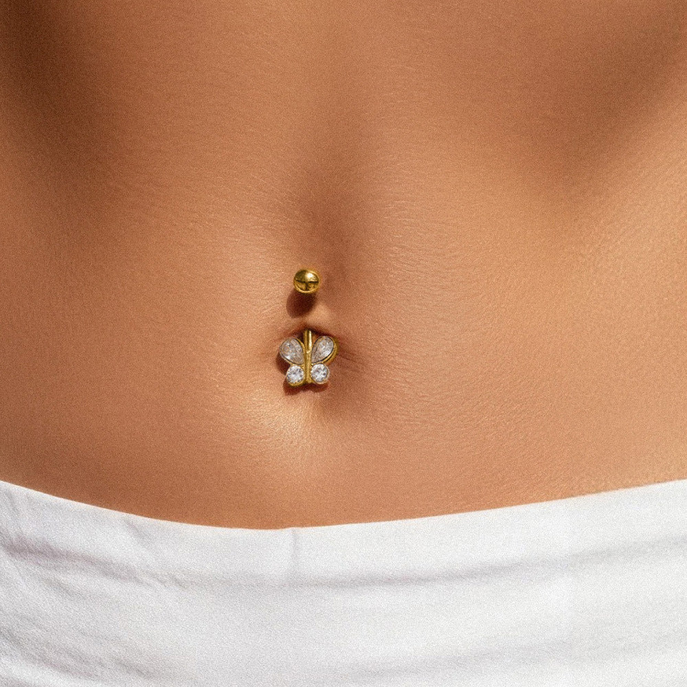 Minimal gold belly button ring on model with smooth polished finish, 316L stainless steel navel ring