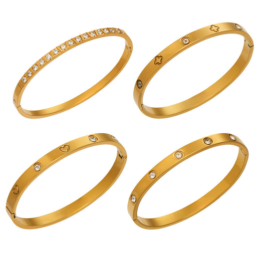 Four slim 316L stainless steel stackable bangles in an 18K PVD gold finish