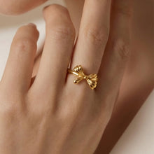 Chic bow open ring in stainless steel with gold PVD finish worn by model