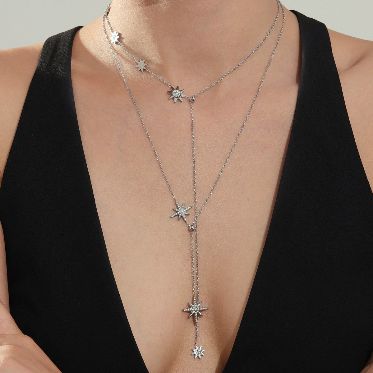 Model wearing silver 316L stainless steel celestial star tassel necklace with zircon, modern minimalist style