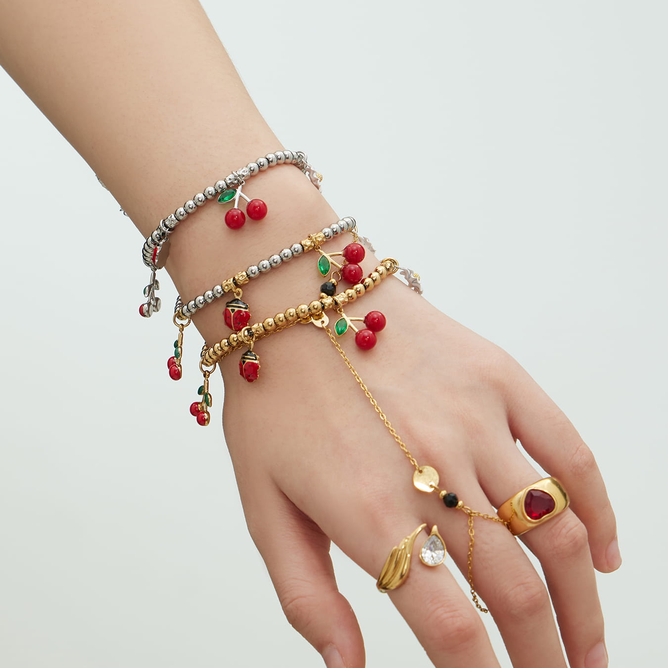 316L stainless steel cherry and ladybug charm bracelet wrist close up
