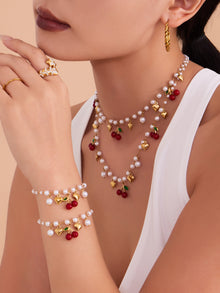 A chic heart and cherry pendant necklace made of tarnish-free stainless steel for a sophisticated summer look.