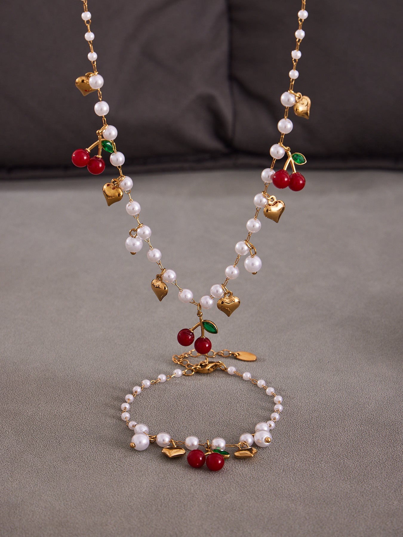 Colorful beaded necklaces with heart and cherry charms displayed on a clean background for wholesale selection.