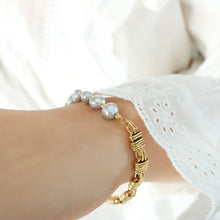 Close-up of gold grey pearl bracelet worn on wrist for boutique gift jewelry and feminine bracelet displays
