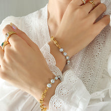 Model wearing grey freshwater pearl bracelet with gold plated copper accents for elegant everyday jewelry styling
