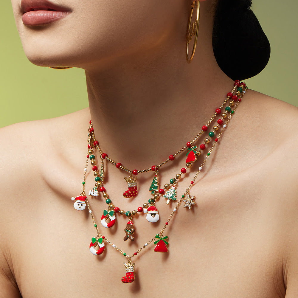 Close-up 316L stainless steel Christmas beaded charm necklace on collarbone with enamel holiday charms
