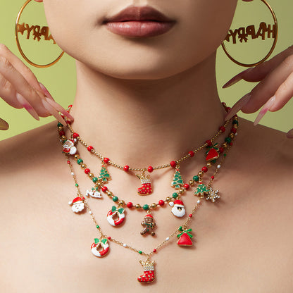 Model wearing layered 316L stainless steel Christmas beaded charm necklaces with holiday pendants