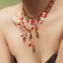 Model wearing 316L stainless steel Christmas charm beaded necklace, enamel holiday charms and zircon accents in gold tone