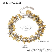 Chunky heart charm bracelets stacked in gold and steel tones for fashion jewelry editorial styling