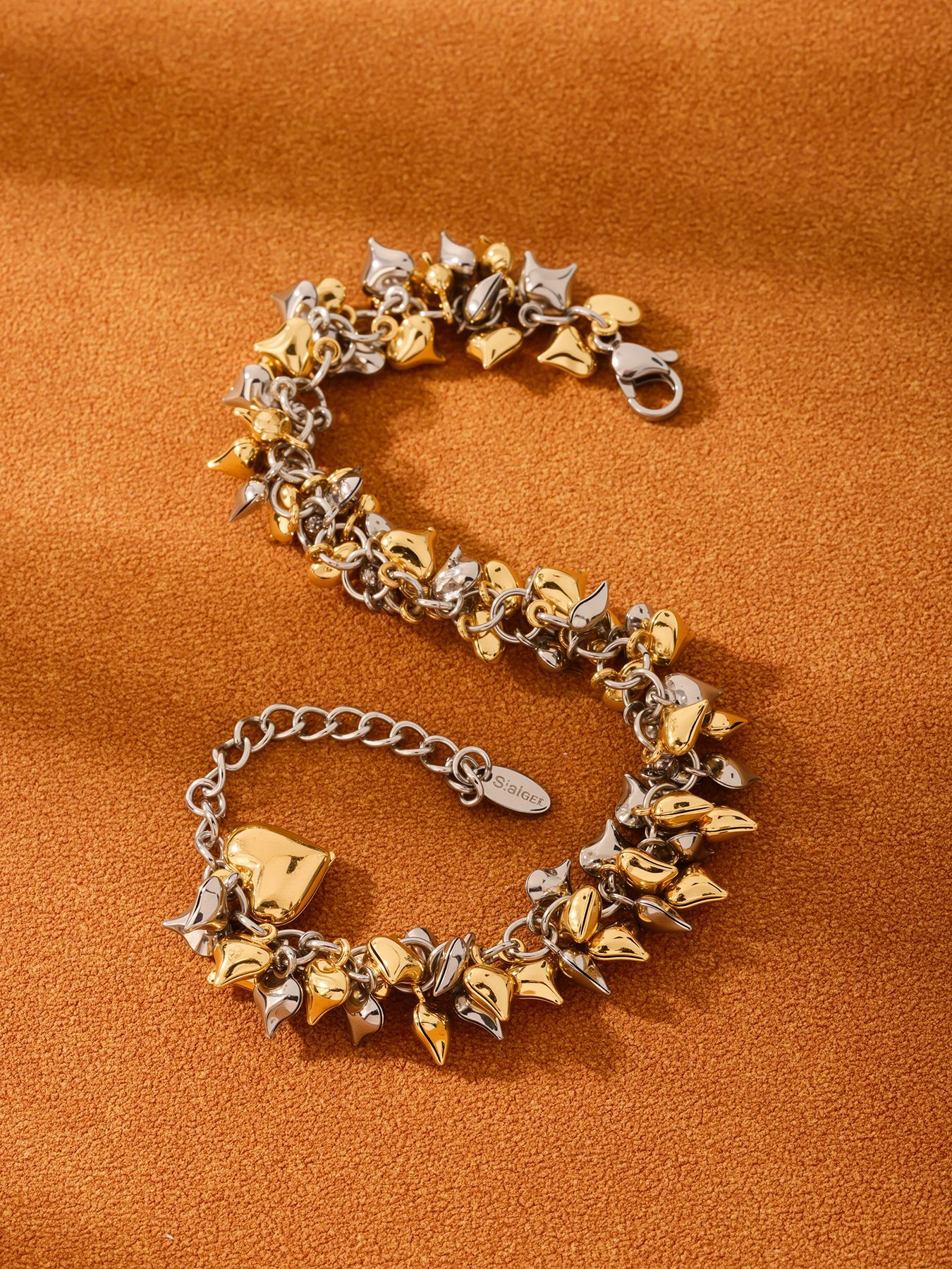 316L stainless steel chunky heart charm bracelet in two-tone gold and steel flat lay