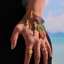 Colorful enamel charm bracelet worn on hand for boutique jewelry styling