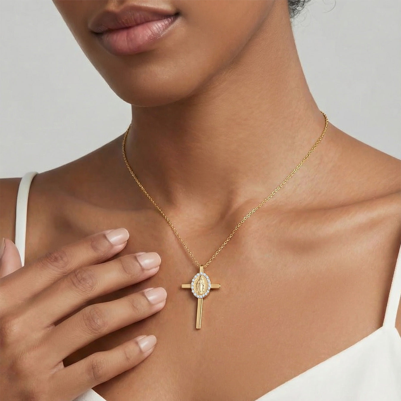 Gold plated 316L stainless steel cross necklace worn on model hand