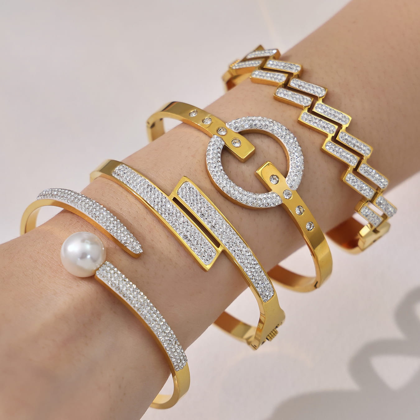 316L stainless steel CZ bangle bracelet set layered on wrist in 18K PVD gold for wholesale