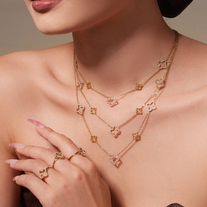 Model wearing 316L stainless steel CZ clover necklace in gold for styling reference
