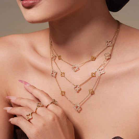 Model wearing 316L stainless steel CZ clover necklace in gold for styling reference