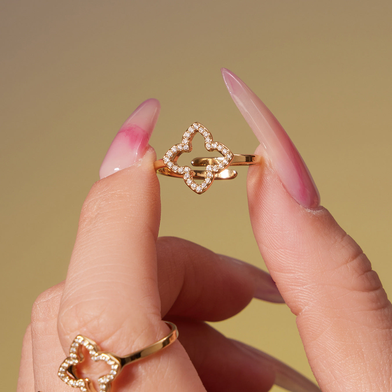 Close up detail of 316L stainless steel CZ clover open ring with gold plating