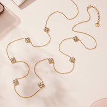 Flat lay of 316L stainless steel CZ flower station long necklace in gold