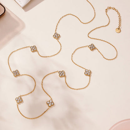 Flat lay of 316L stainless steel CZ flower station long necklace in gold