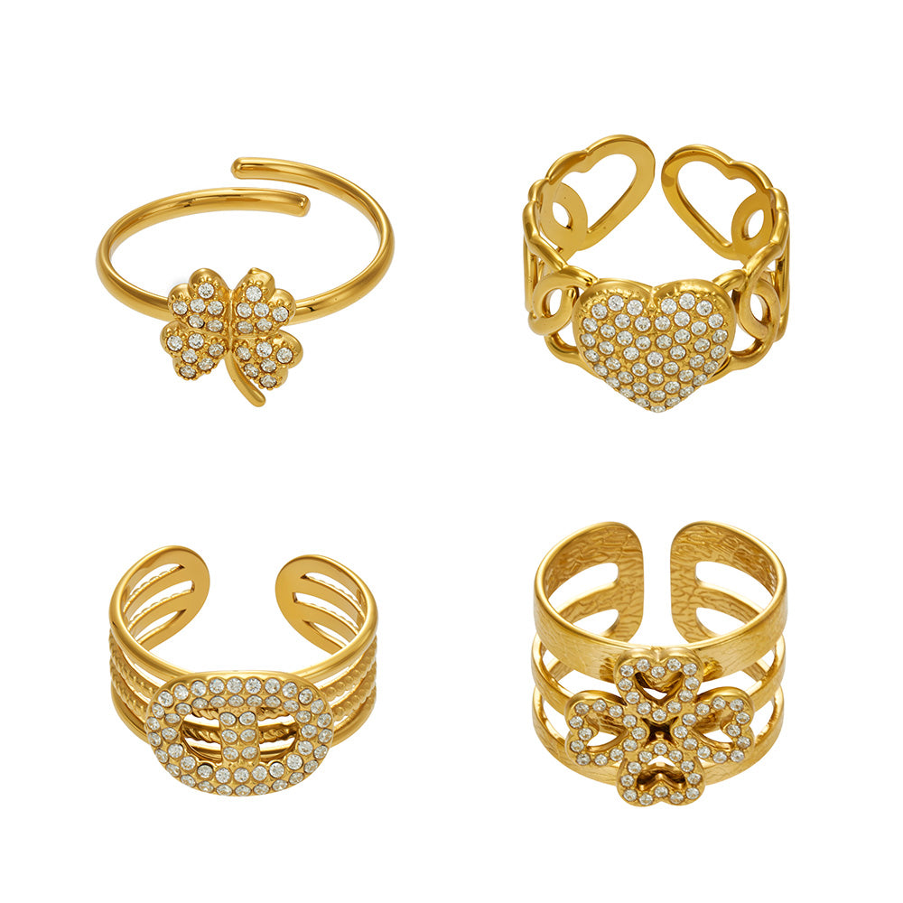 Collection of 316L stainless steel cubic zirconia open rings in floral heart and sculptural designs with 18K PVD gold finish