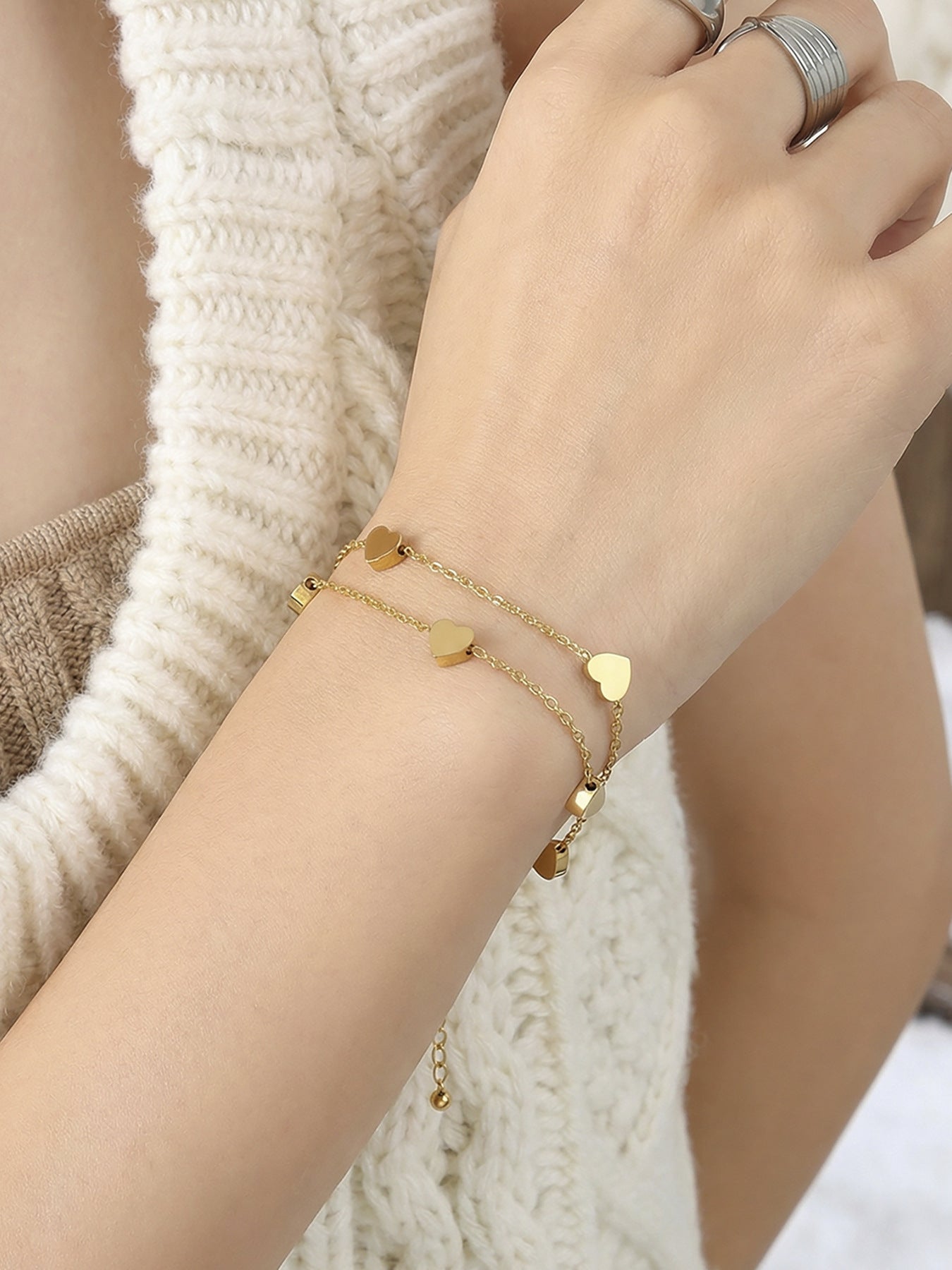 Model wearing 316L stainless steel double layer heart chain bracelet, waterproof everyday wear jewelry