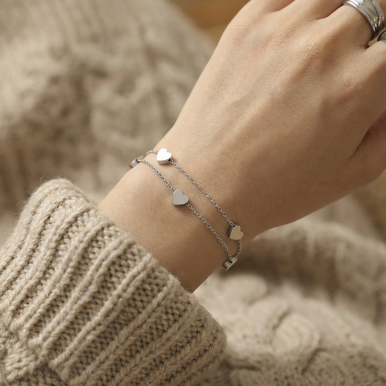 Detail of 316L stainless steel double layer heart chain bracelet, heart charm with PVD gold plating