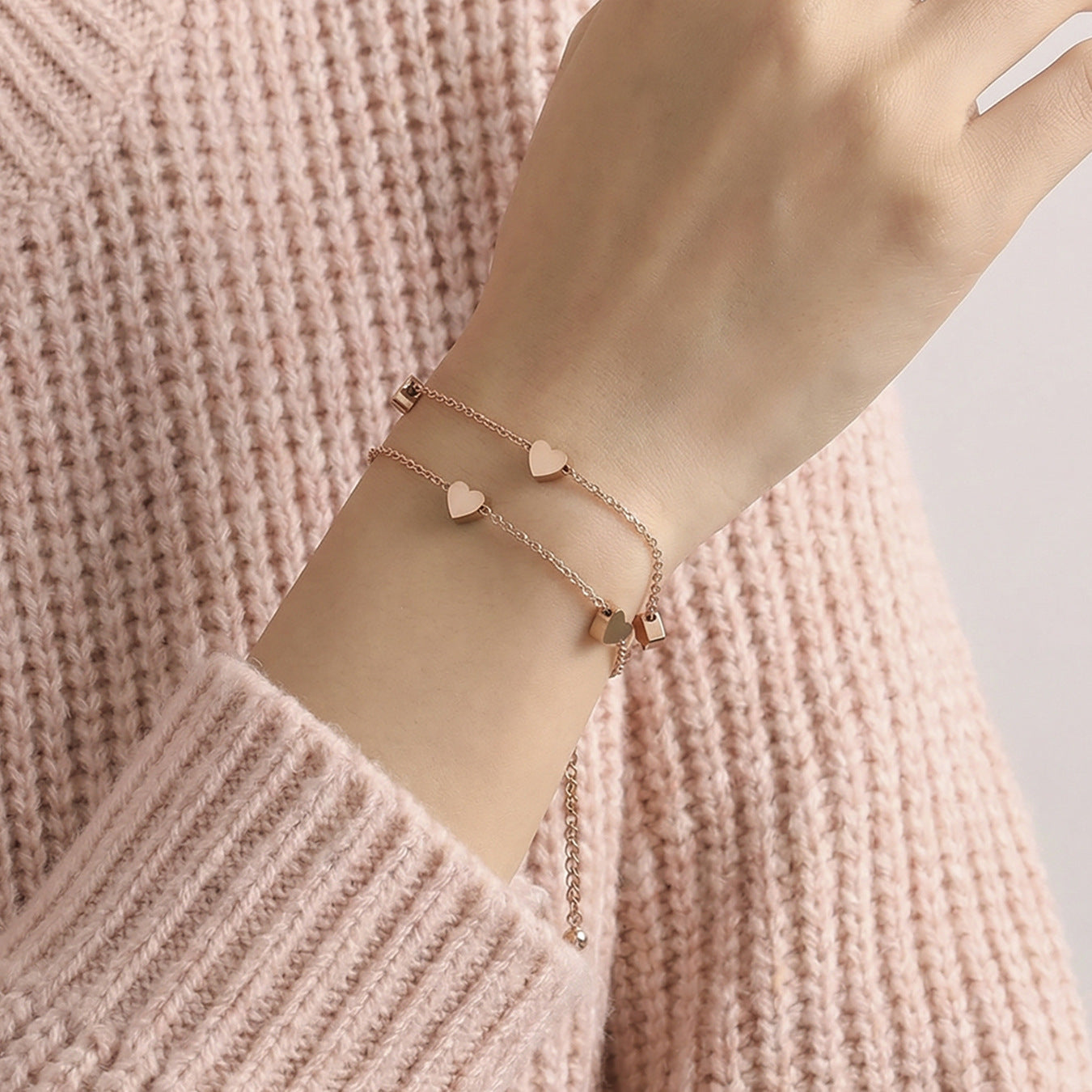 Model wearing 316L stainless steel double layer heart chain bracelet, romantic stackable design