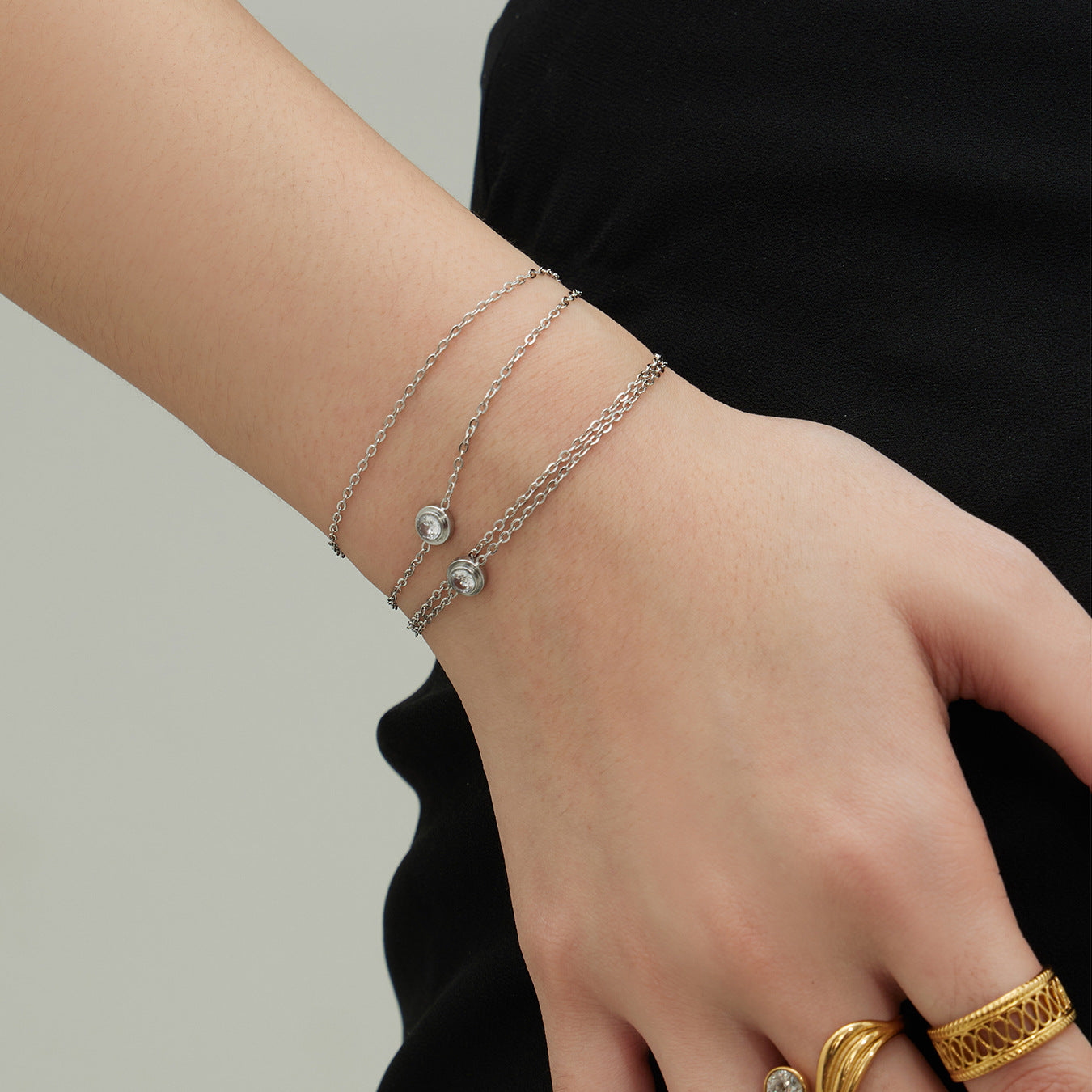 Silver tone 316L stainless steel double-layer zircon bracelet worn on wrist, minimalist look
