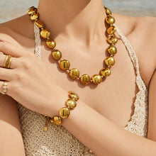 Elegant gold droplet bracelet showcasing a sleek design