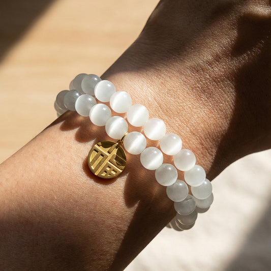 Model wearing 316L Stainless Steel cat's eye stone bead bracelet with lucky charm pendant, hypoallergenic