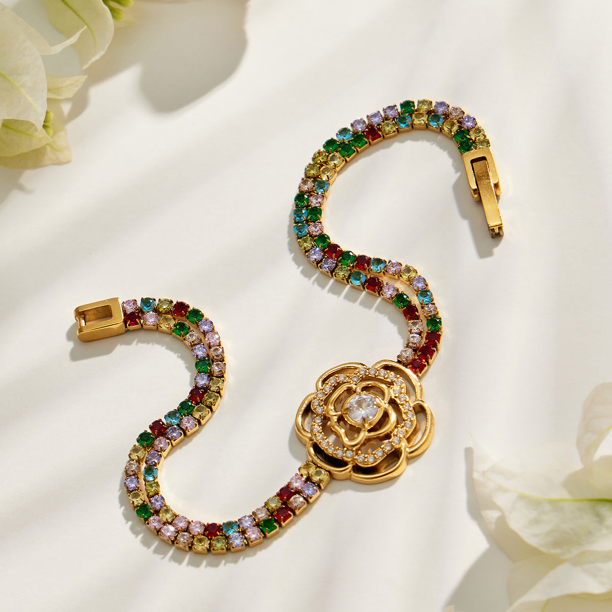 Gold multicolor zircon bracelet with large floral centerpiece shown in a close-up product view