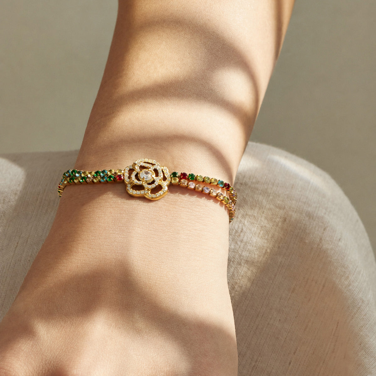 Multicolor flower zircon bracelet in gold finish worn on the wrist