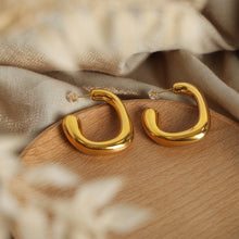 Gold PVD plated 316L stainless steel geometric hoop earrings displayed in jewelry box