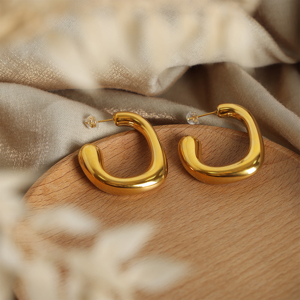 Gold PVD plated 316L stainless steel geometric hoop earrings displayed in jewelry box