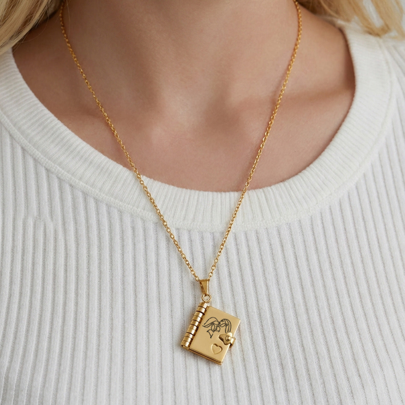 Model wearing 316L stainless steel gold book pendant necklace with engraved love message design
