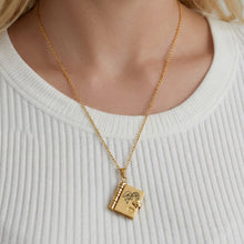Model wearing 316L stainless steel gold book pendant necklace with engraved love message design