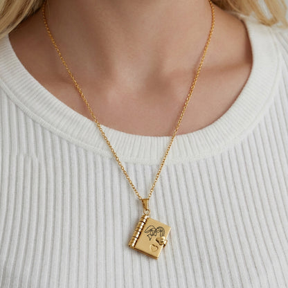 Model wearing 316L stainless steel gold book pendant necklace with engraved love message design