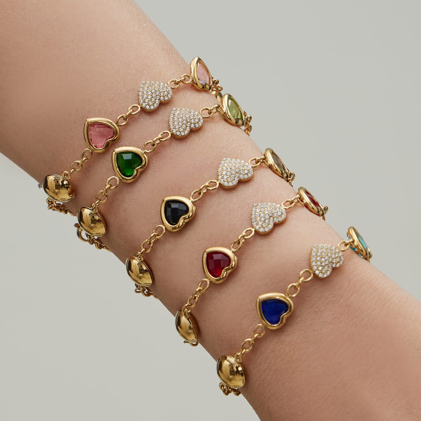 Close up of 316L stainless steel heart charm bracelet stack designed for wholesale jewelry supply